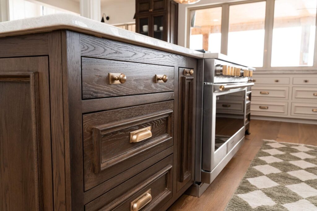 A kitchen with a stove and drawers.