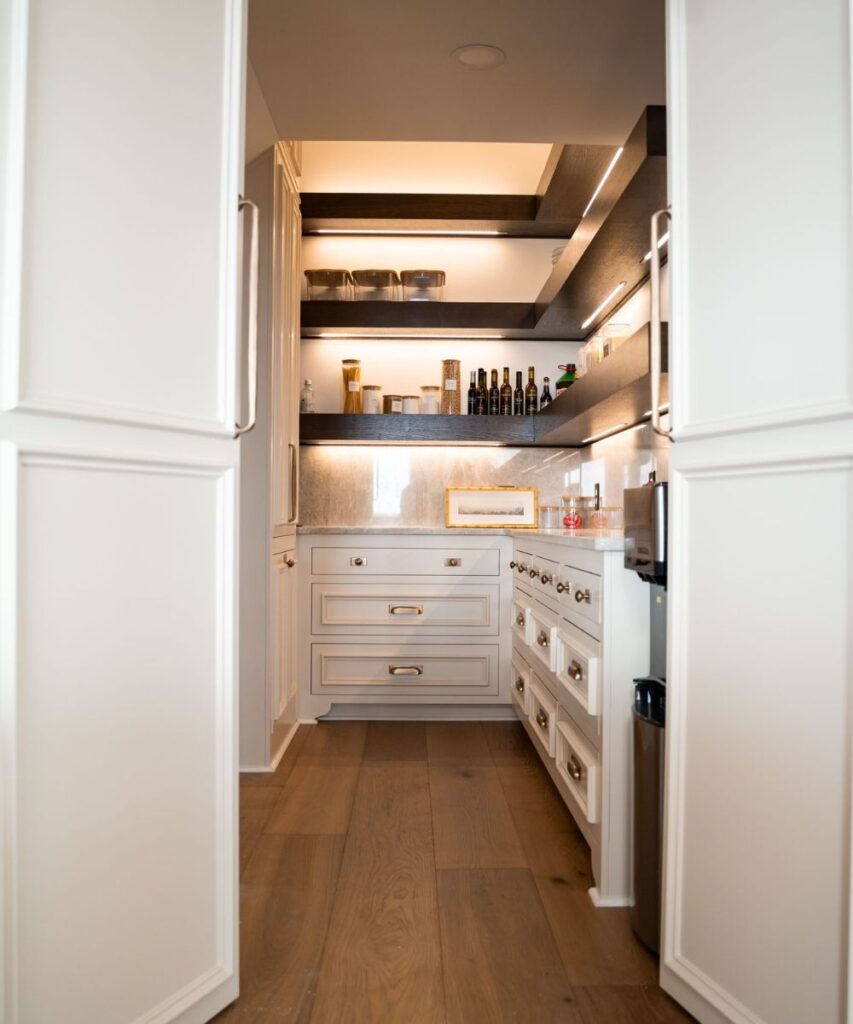 A kitchen with shelves and cabinets.